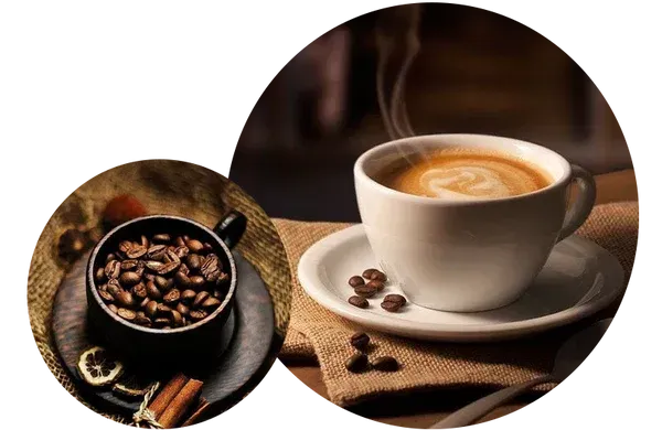 Fresh coffee beans beside a steaming cup